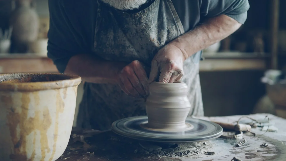 A potter concentrating on shaping clay at a wheel
